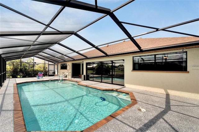 view of swimming pool with a lanai and a patio area