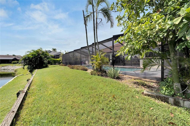 view of yard with a fenced in pool, glass enclosure, and a water view