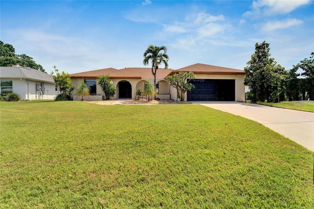 view of front facade with a front yard and a garage