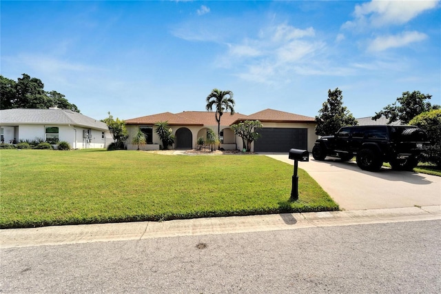 view of front of property with a front lawn and a garage