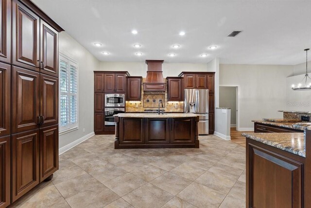 kitchen with backsplash, premium range hood, an inviting chandelier, decorative light fixtures, and stainless steel appliances