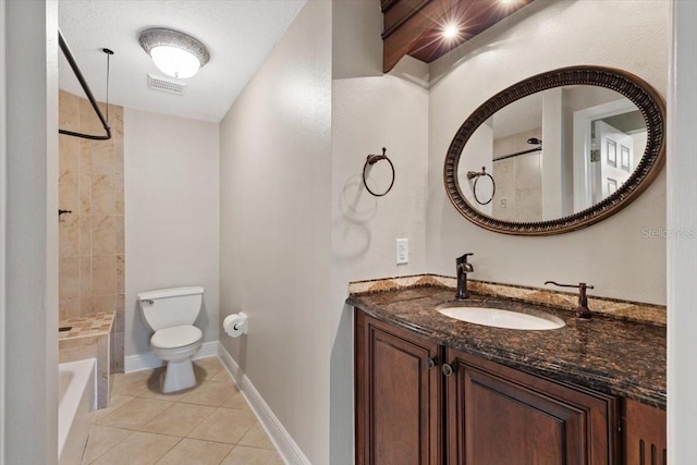 bathroom with toilet, vanity, and tile patterned floors