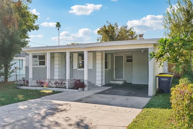 view of front of property with a porch and a carport