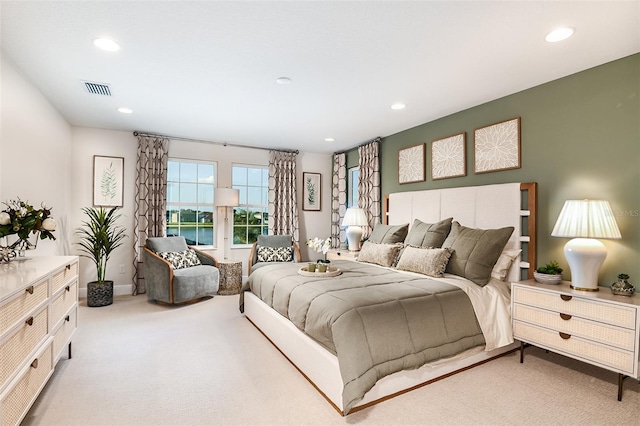 carpeted bedroom with a water view