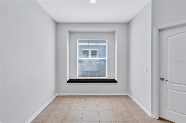 spare room featuring light tile patterned floors