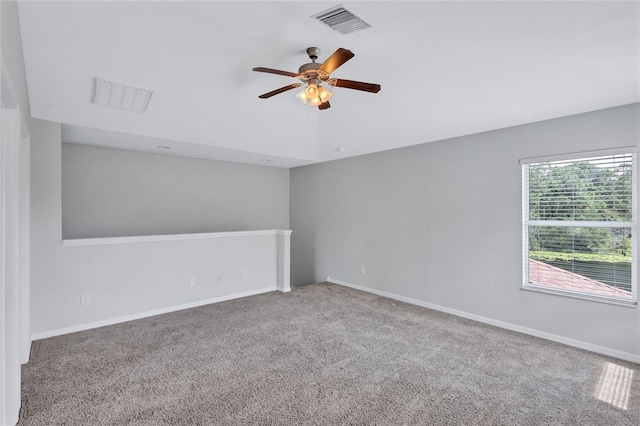 spare room featuring ceiling fan and carpet floors