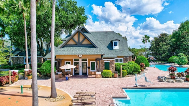 view of pool featuring french doors and a patio