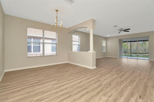 unfurnished room with light hardwood / wood-style flooring, plenty of natural light, and ornate columns