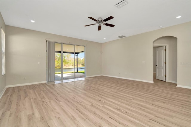 spare room with ceiling fan and light wood-type flooring