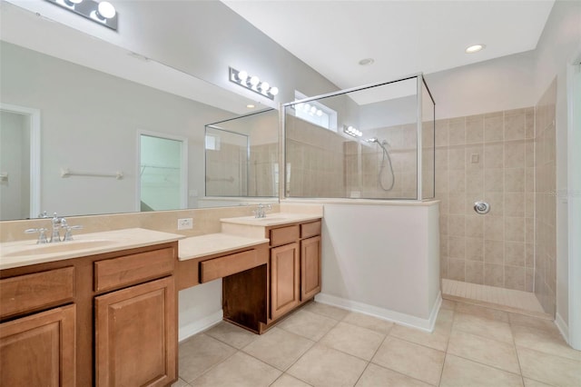 bathroom with tiled shower, vanity, and tile patterned flooring