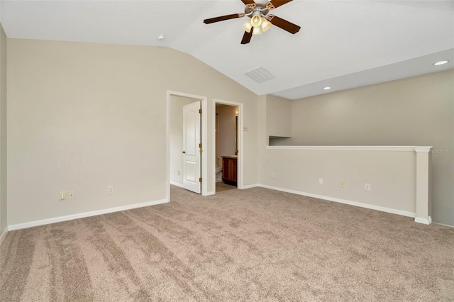 carpeted empty room with vaulted ceiling and ceiling fan