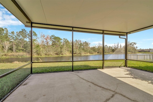 unfurnished sunroom featuring a water view