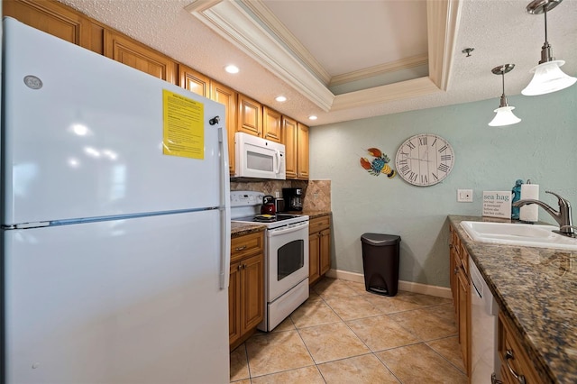 kitchen with ornamental molding, white appliances, sink, hanging light fixtures, and a tray ceiling