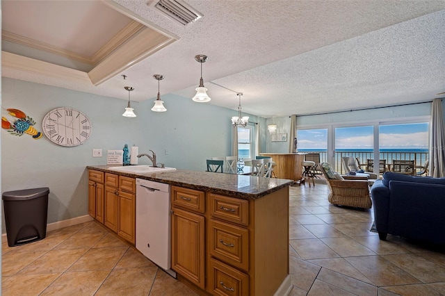 kitchen with dishwasher, a textured ceiling, kitchen peninsula, and decorative light fixtures