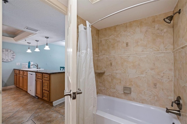 bathroom with vanity, a textured ceiling, shower / tub combo with curtain, and tile patterned flooring