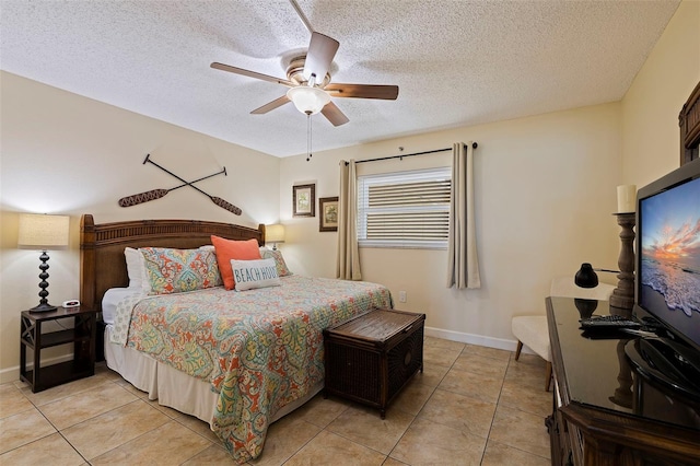 bedroom with a textured ceiling, ceiling fan, and light tile patterned floors