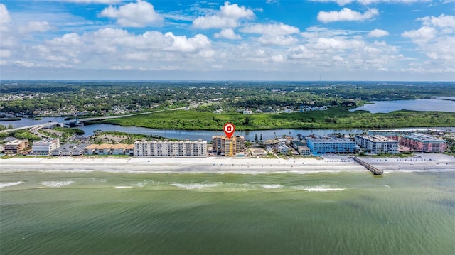 drone / aerial view with a beach view and a water view