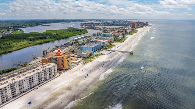 bird's eye view featuring a water view and a beach view