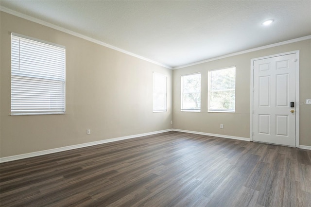 unfurnished room featuring crown molding and dark hardwood / wood-style floors