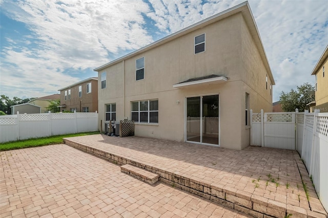 back of property with a patio