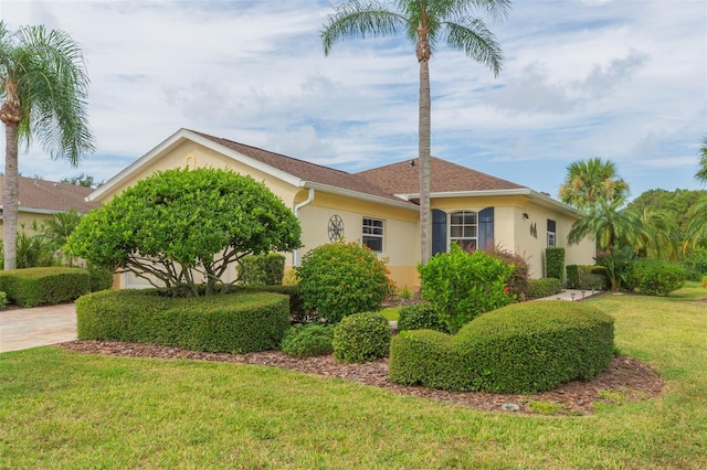 view of front facade with a front yard and a garage