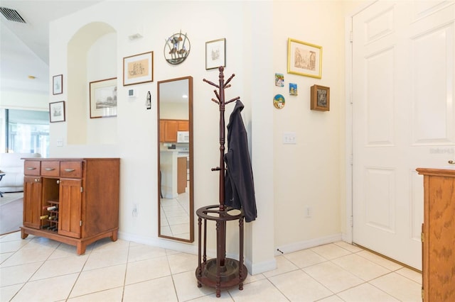 hall featuring light tile patterned flooring