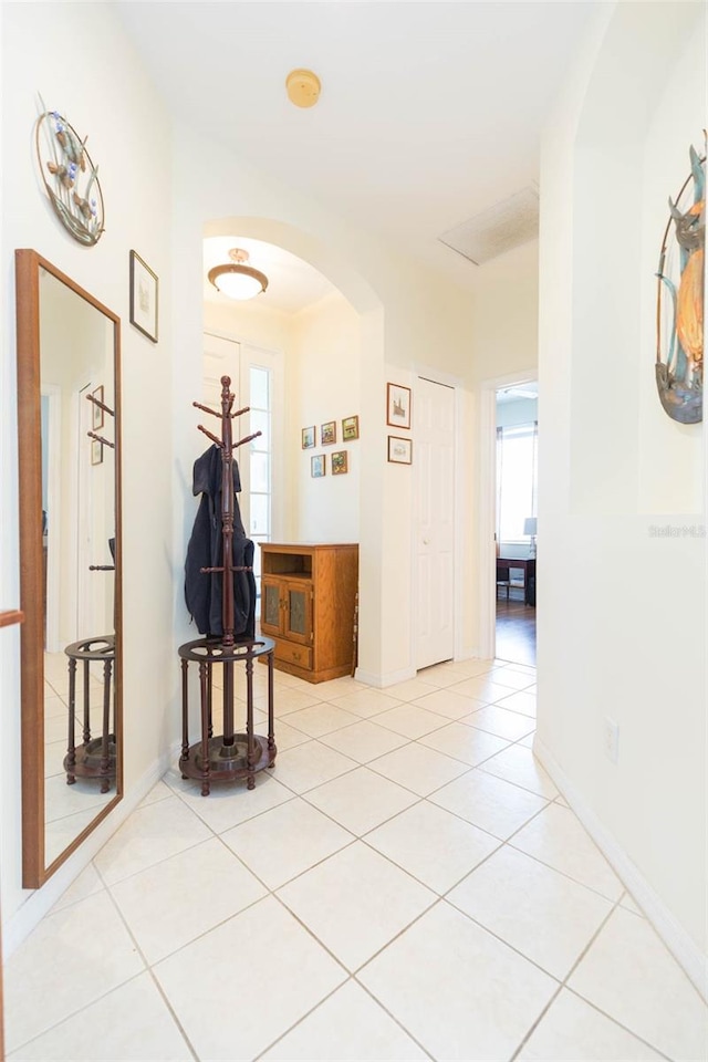 hall featuring light tile patterned flooring