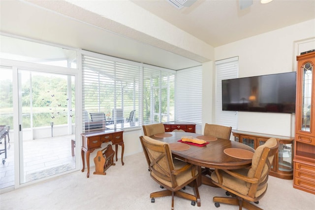 dining area featuring light carpet