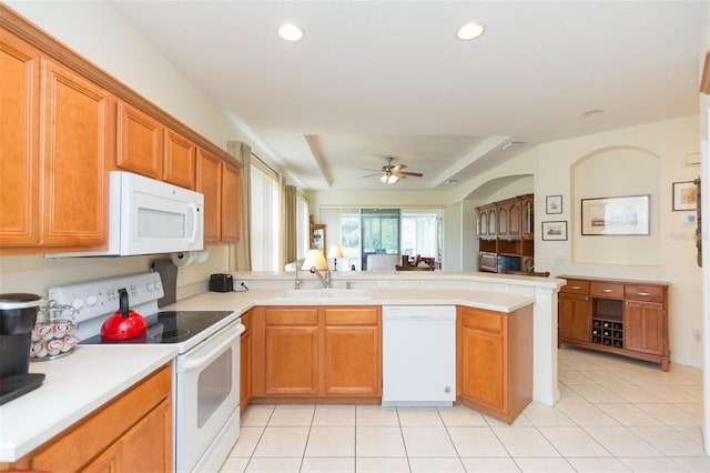 kitchen featuring ceiling fan, light tile patterned flooring, sink, kitchen peninsula, and white appliances