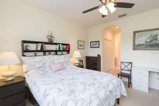 bedroom featuring light carpet, ceiling fan, and a closet