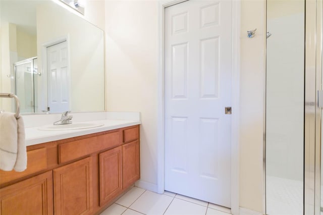 bathroom with vanity, tile patterned flooring, and a shower with shower door