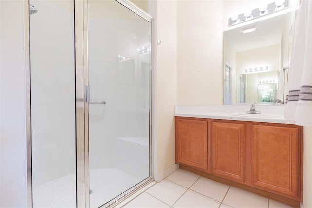 bathroom featuring walk in shower, vanity, and tile patterned floors