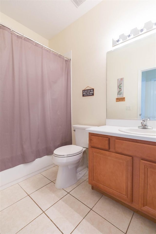 full bathroom with shower / tub combo with curtain, vanity, toilet, and tile patterned floors