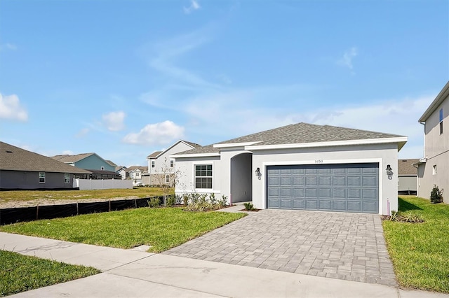 single story home featuring a front lawn and a garage