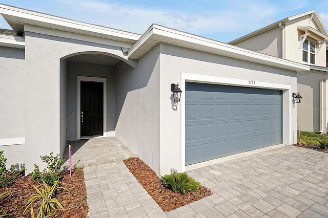 view of exterior entry featuring a garage