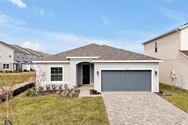 view of front of home with a front lawn and a garage