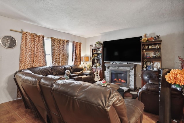 living room featuring a fireplace and a textured ceiling