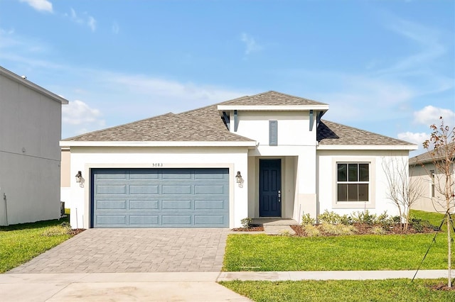 view of front of house featuring a front yard and a garage