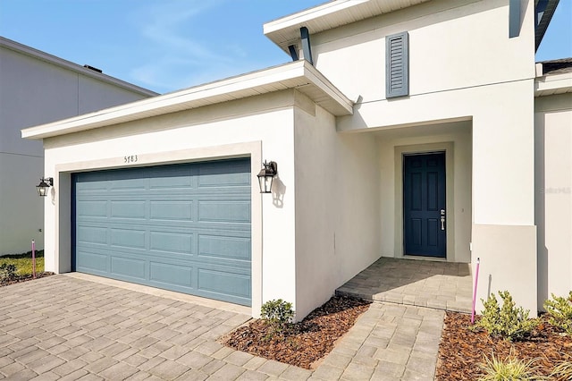 view of exterior entry with a garage