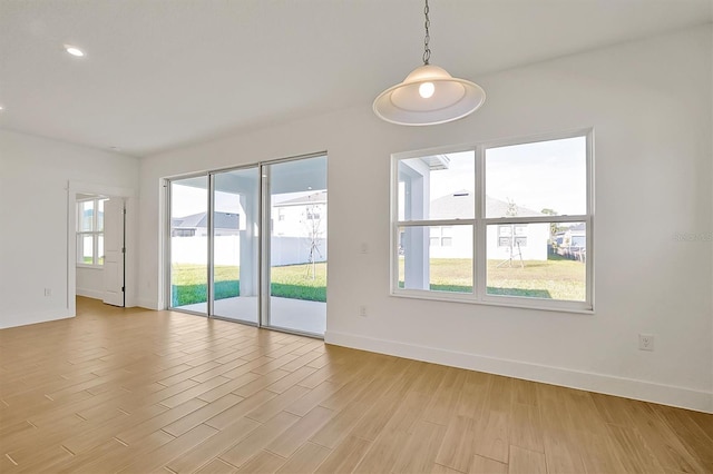 unfurnished room with light wood-type flooring