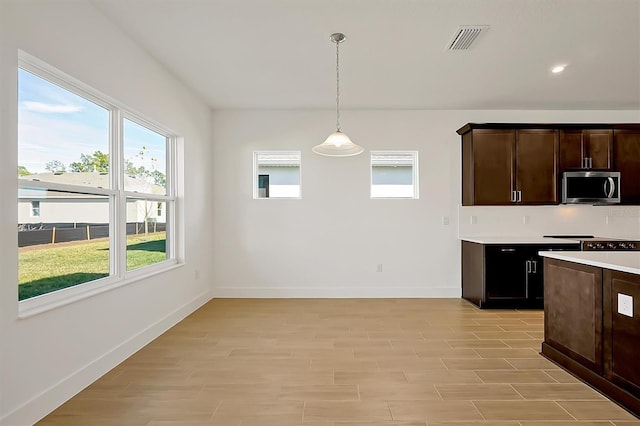 kitchen featuring dark brown cabinets and decorative light fixtures