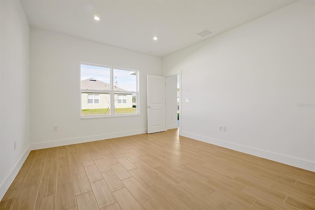 unfurnished room with light wood-type flooring