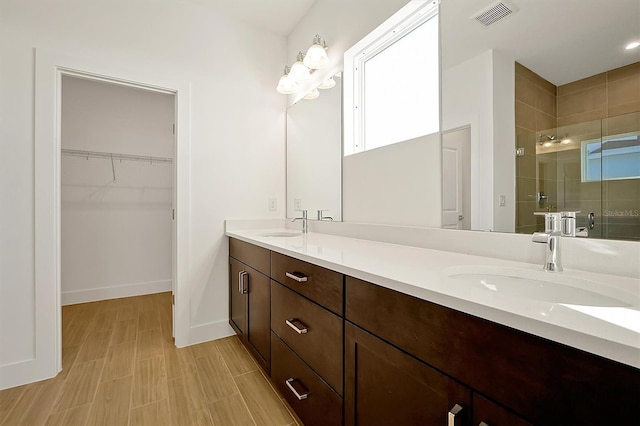 bathroom with vanity and a shower with door