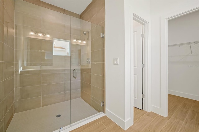 bathroom featuring a shower with door