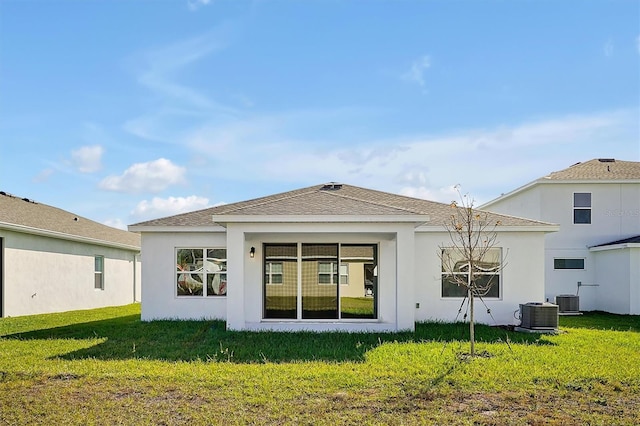 back of property featuring a lawn and cooling unit