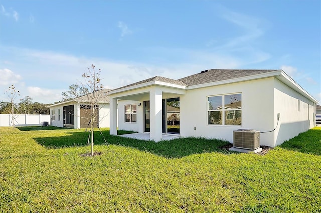 back of property with a patio, a lawn, and central air condition unit