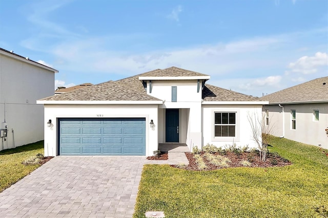 view of front of house featuring a front lawn and a garage