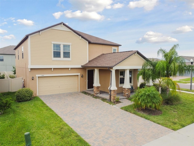 view of front of home with a garage and a front yard