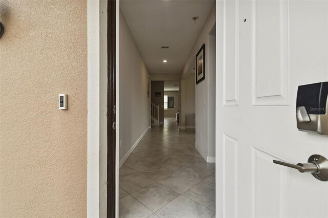 hall featuring light tile patterned floors