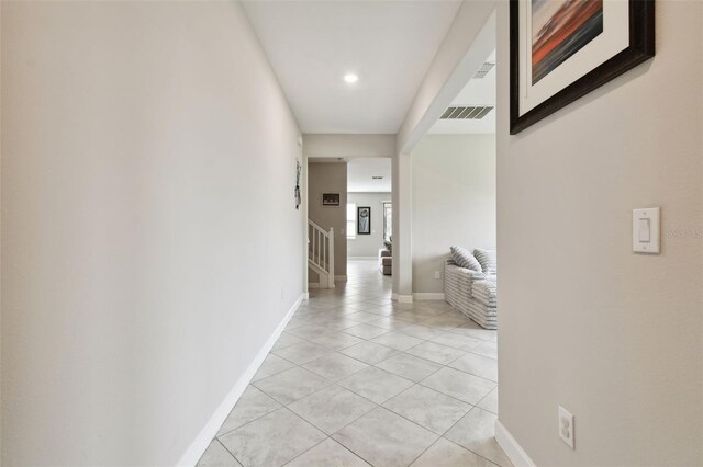 hall featuring light tile patterned flooring